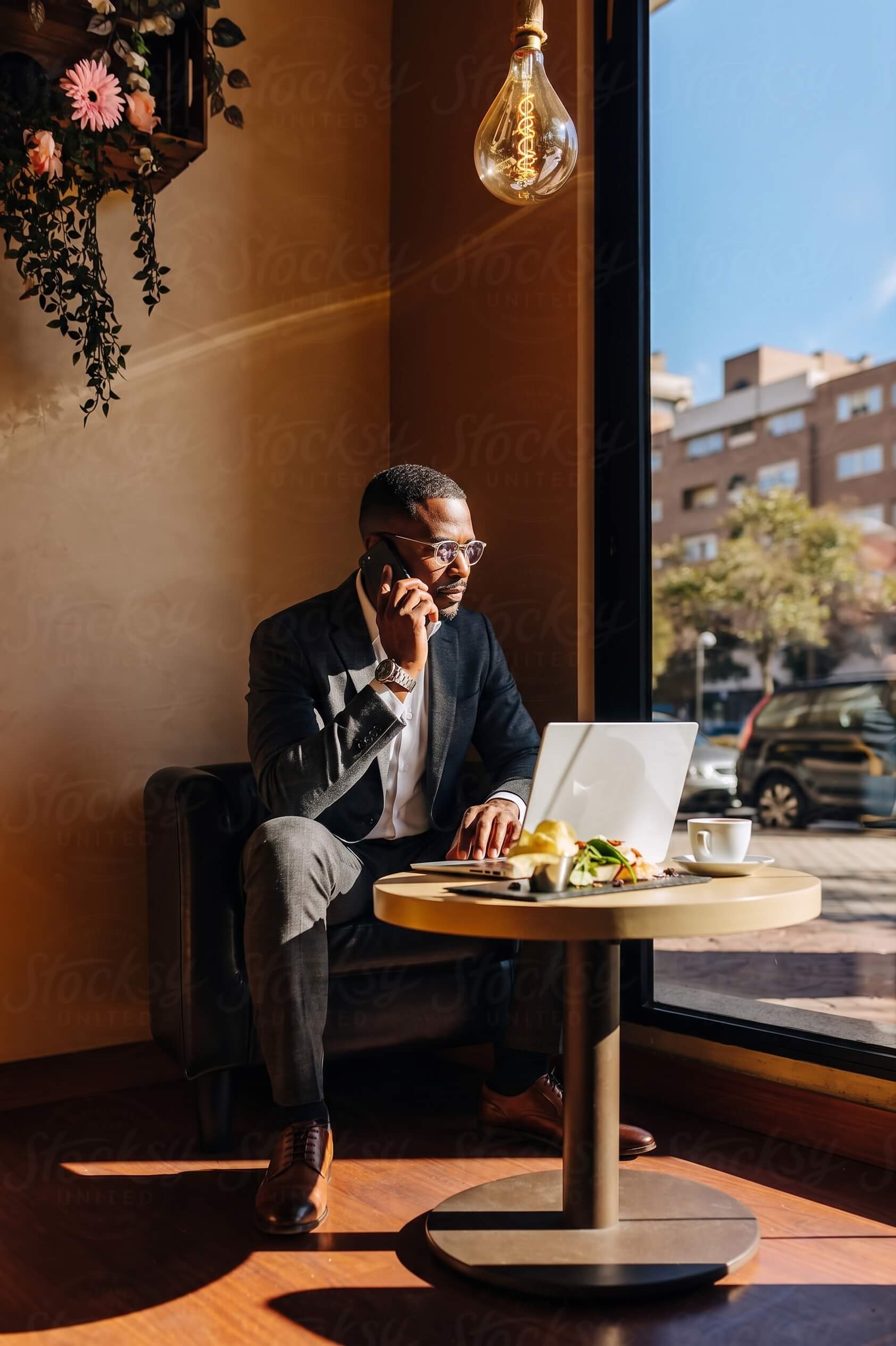 Man in his mid-50s in a business setting, engaged in a phone call