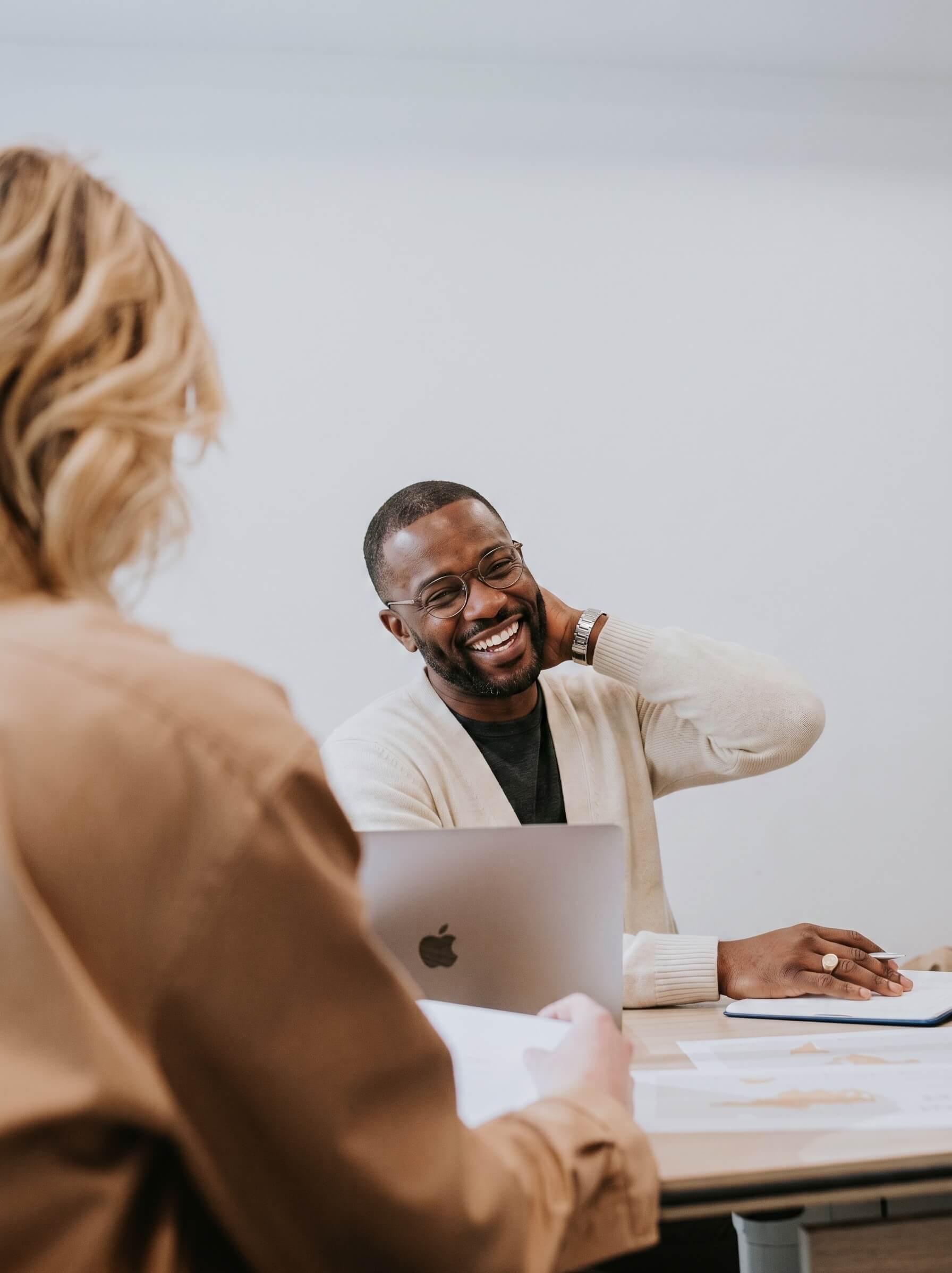 Man smiling and engaged during a team meeting