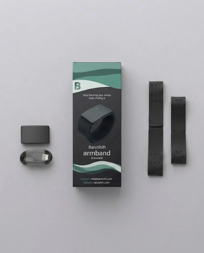 The BaroShift Armband box with the sensor, charging cable and two straps laid out