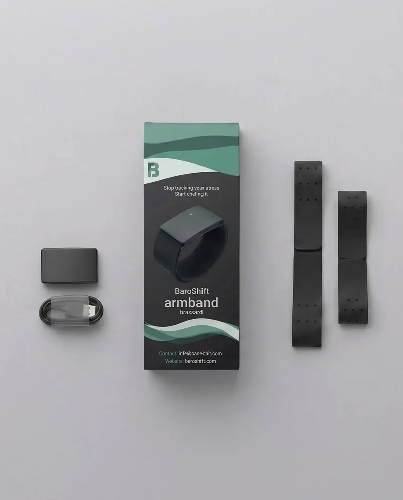 The BaroShift Armband box with the sensor, charging cable and two straps laid out